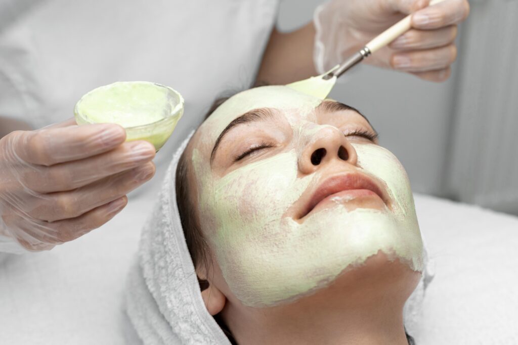 beautician-applying-face-mask-female-client (1)
